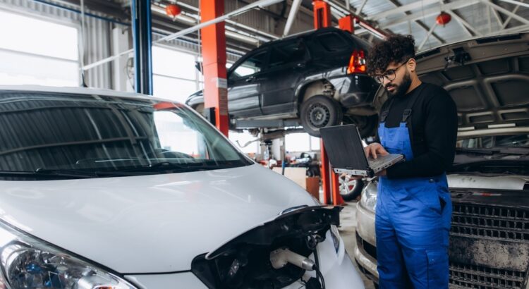 Image of a mechanic performing a diagnostic check on an electric vehicle.